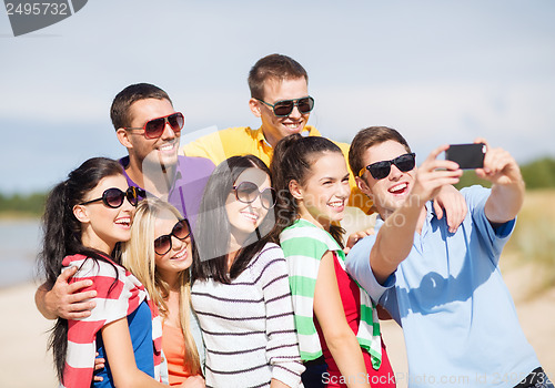 Image of group of friends taking picture with smartphone