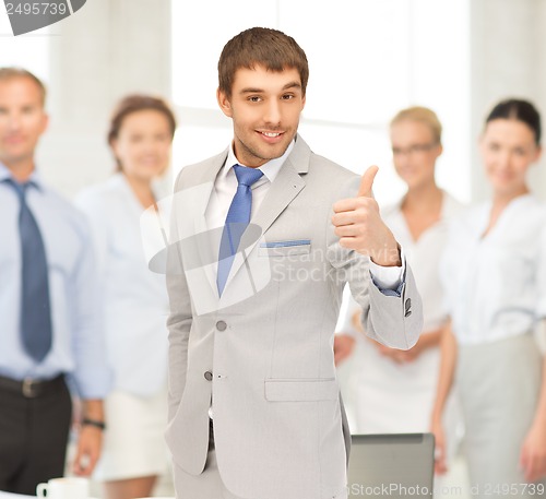 Image of smiling businessman with thumbs up