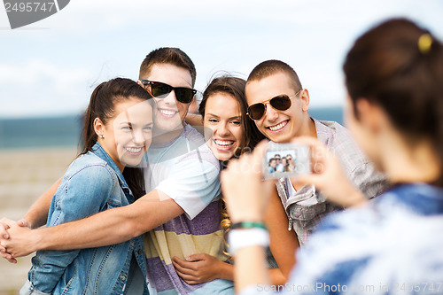 Image of teenagers taking photo outside