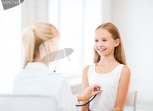 Image of doctor with stethoscope listening to the patient