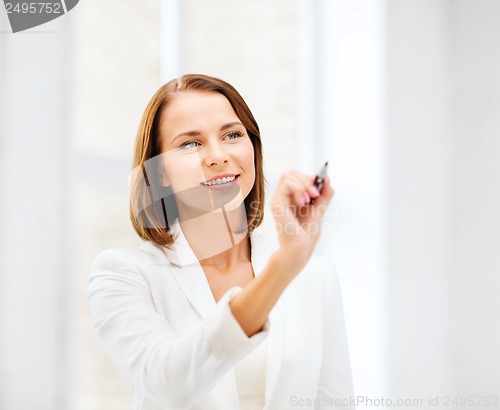 Image of woman writing with pen in the air