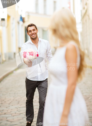 Image of couple with flowers in the city