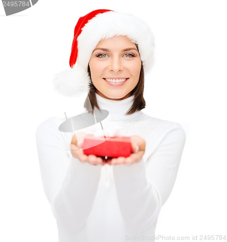 Image of smiling woman in santa hat with small gift box