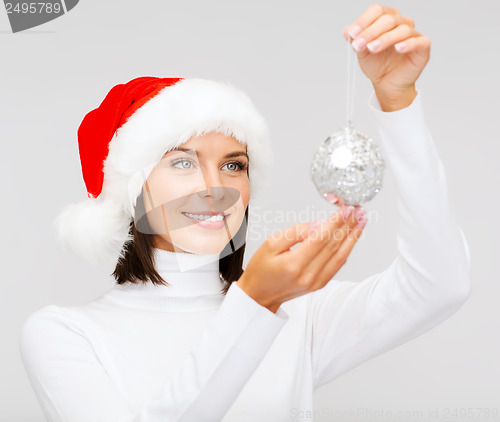 Image of woman in santa helper hat with christmas ball