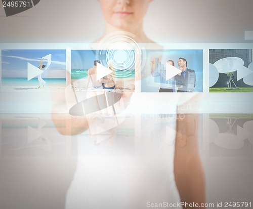 Image of woman pressing button on virtual screen