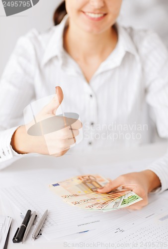 Image of woman hands with euro cash money and thumbs up