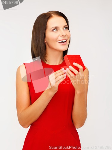 Image of surprised woman in red dress with gift box