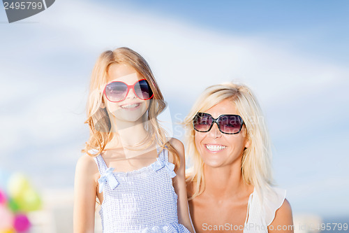 Image of mother and child in sunglasses