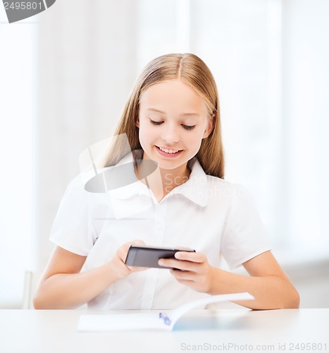 Image of girl with smartphone at school