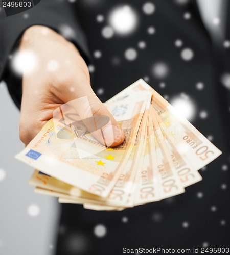 Image of man in suit with euro cash money