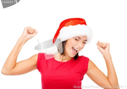 Image of smiling woman in santa helper hat