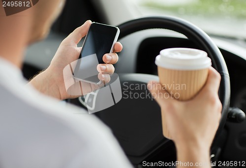 Image of man using phone while driving the car