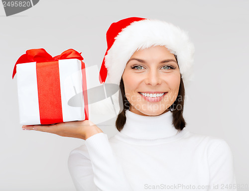 Image of smiling woman in santa helper hat with gift box