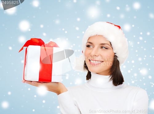 Image of smiling woman in santa helper hat with gift box