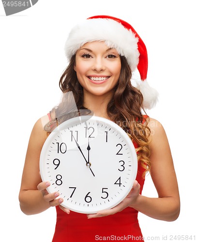 Image of woman in santa helper hat with clock showing 12