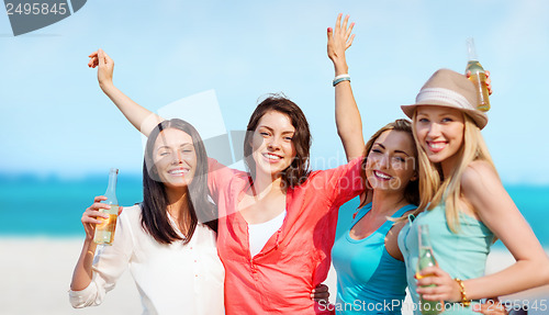 Image of girls with drinks on the beach