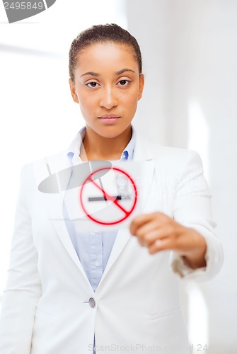 Image of african woman with restriction no smoking sign