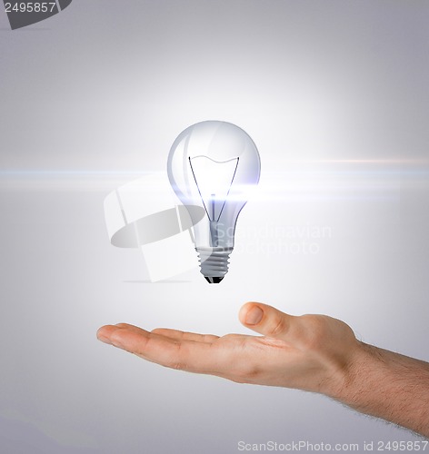 Image of man hand with light bulb