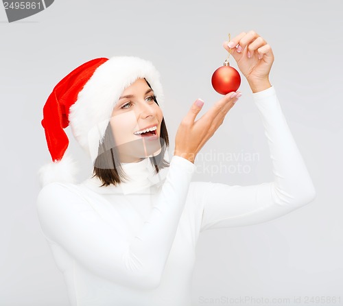 Image of woman in santa helper hat with christmas ball