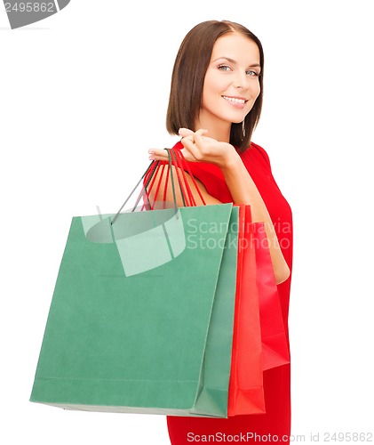 Image of woman in red dress with shopping bags