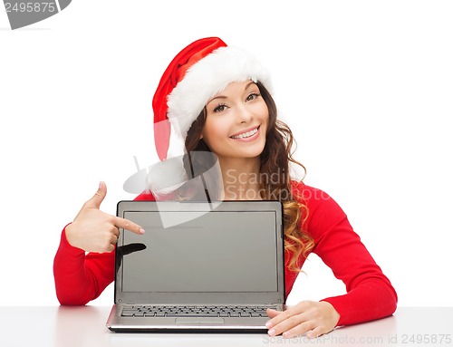 Image of woman in santa helper hat with laptop computer