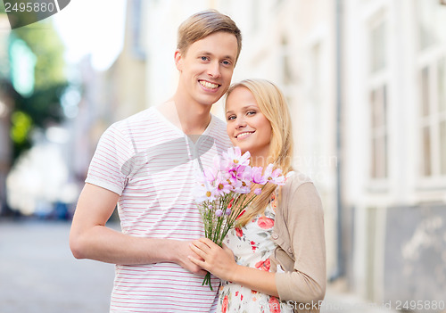 Image of couple with flowers in the city