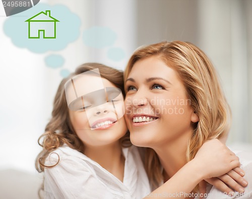 Image of mother and daughter with eco house