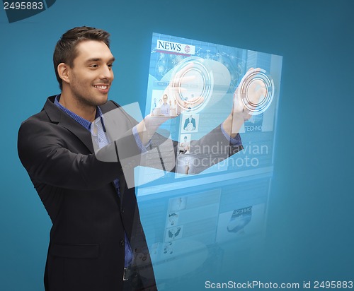 Image of businessman pressing buttons on virtual screen