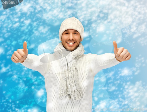 Image of handsome man in warm sweater, hat and scarf