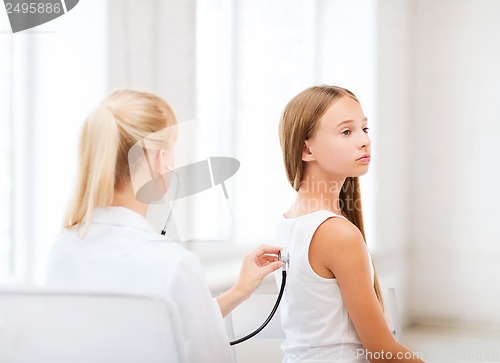 Image of doctor with stethoscope listening to the patient