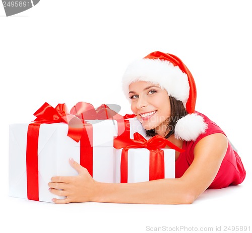 Image of smiling woman in santa helper hat with gift boxes