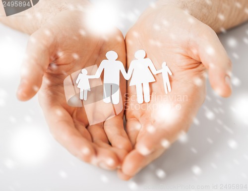 Image of man hands showing family of paper people