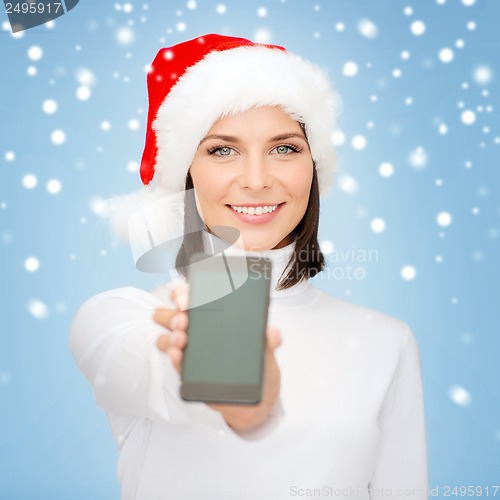 Image of woman in santa helper hat with smartphone