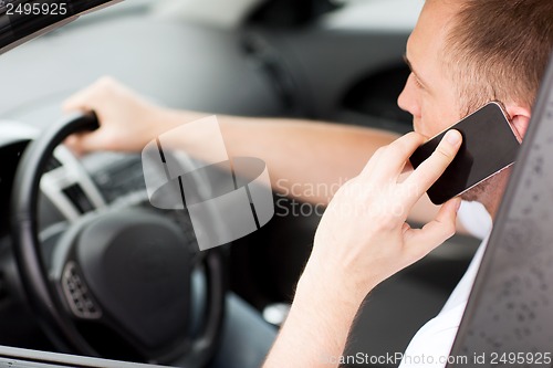 Image of man using phone while driving the car