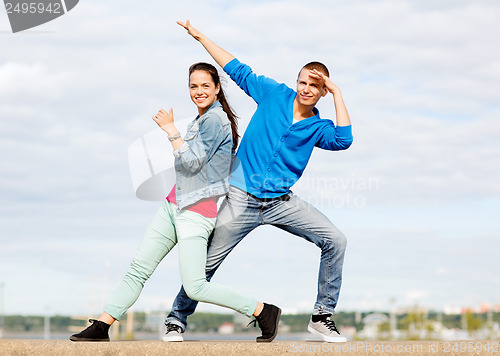 Image of couple of teenagers dancing outside