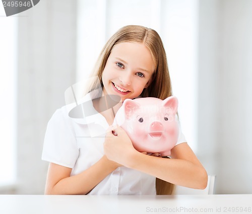 Image of child with piggy bank