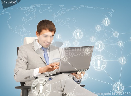 Image of businessman networking with laptop