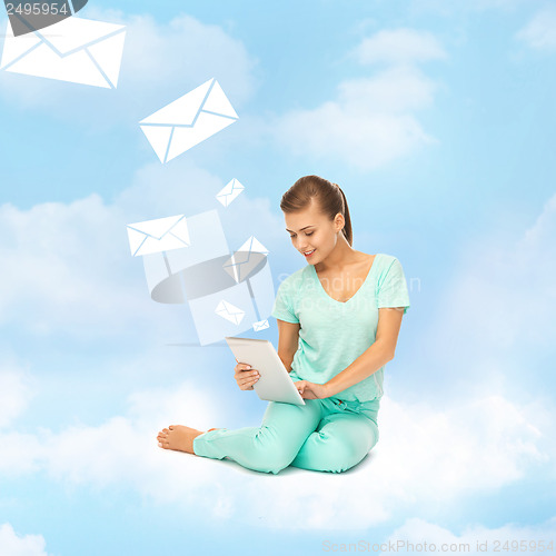 Image of woman sitting on the cloud with tablet pc