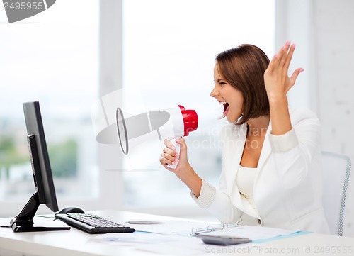 Image of strict businesswoman shouting in megaphone