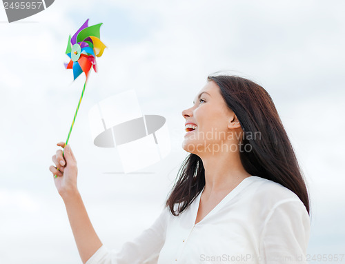 Image of girl with windmill toy on the beach