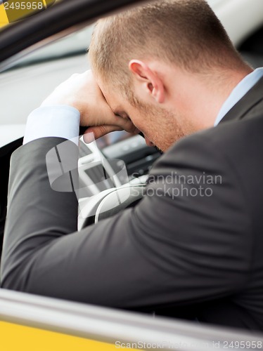 Image of tired businessman or taxi car driver