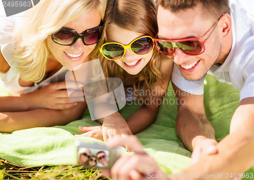 Image of happy family with camera taking picture