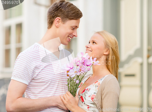 Image of couple with flowers in the city