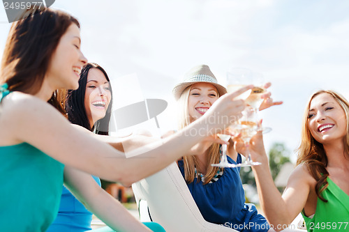 Image of girls with champagne glasses on boat