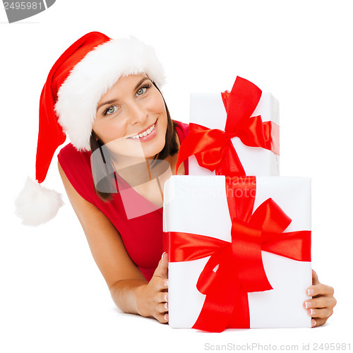 Image of smiling woman in santa helper hat with gift boxes