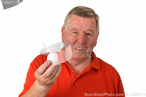 Image of Old man holding an egg