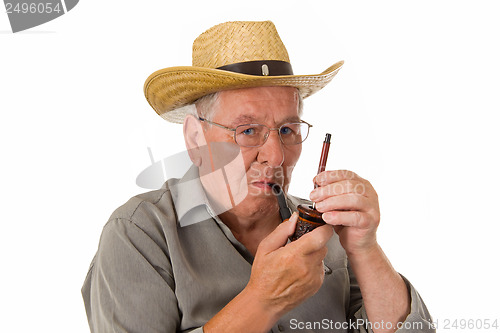 Image of Old man lighting up a pipe