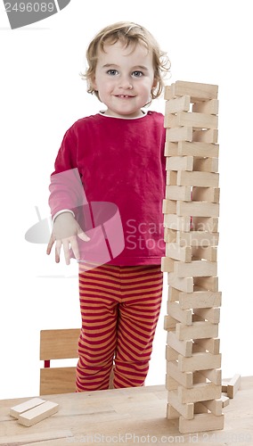 Image of child with tower made of 	toy blocks