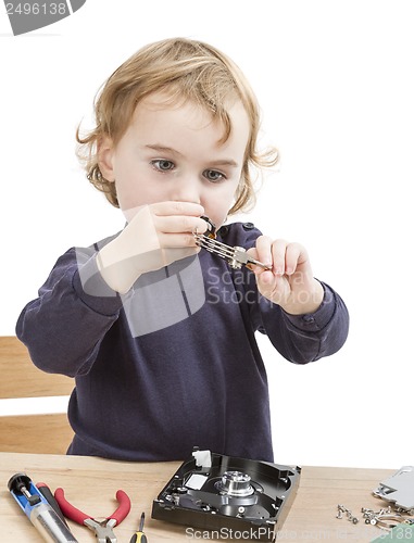 Image of little girl repairing computer parts