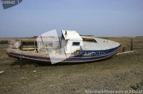 Image of Small boat in the mud